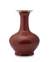 A CHINESE CERAMIC OX BLOOD VAS