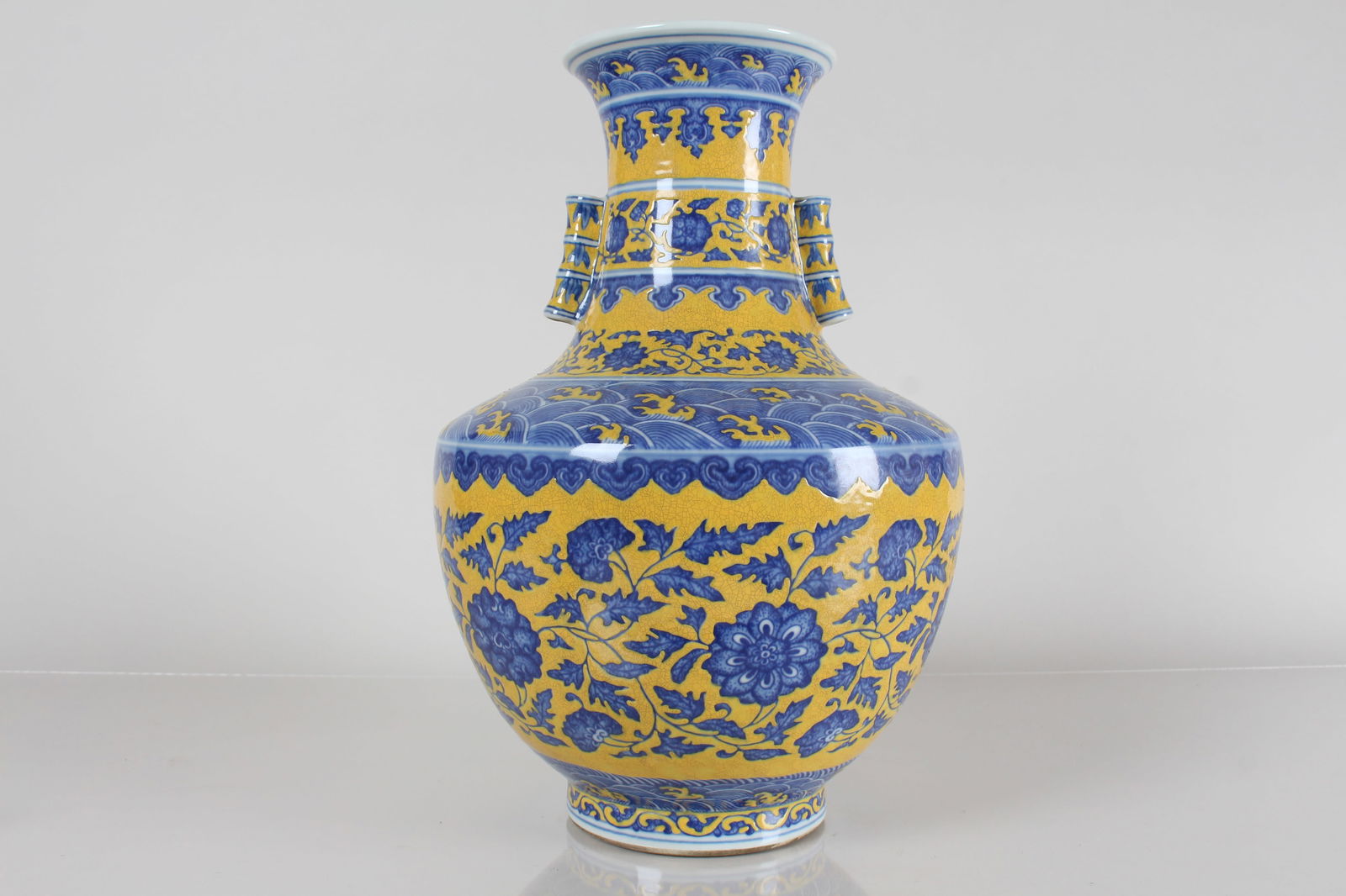 A CHINESE DUO-HANDLED YELLOW-CODING