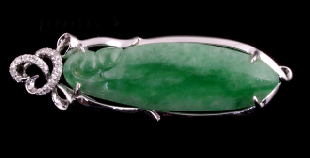 A Chinese green stone pendant of