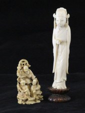 A Chinese ivory group of an im
