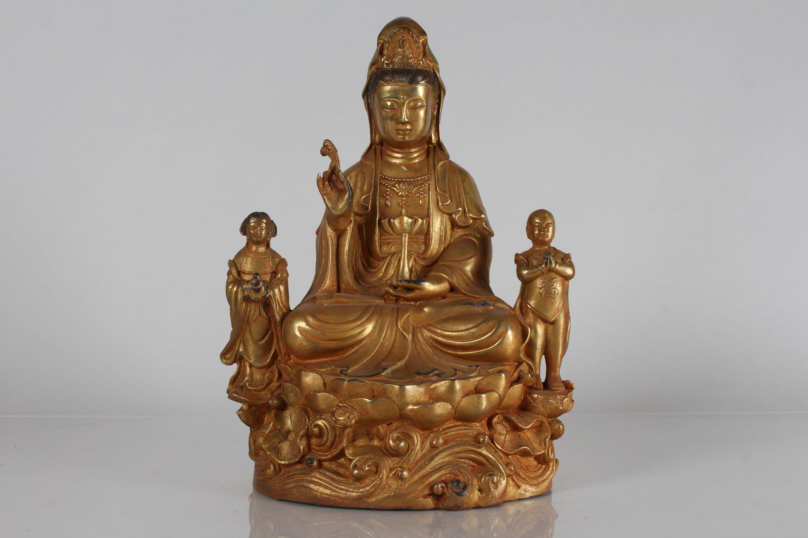 A CHINESE JOYFUL-KID RELIGIOUS GILT