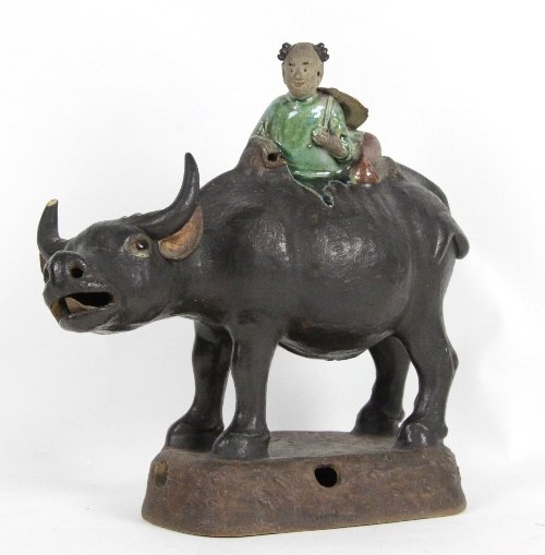 A Chinese pottery figure of a boy