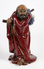 A CHINESE SHIWAN GLAZED FIGURE