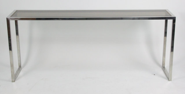 A chrome and glass table of