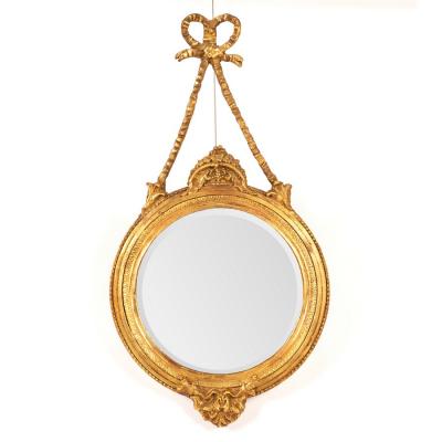 A circular gilt framed wall