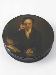A circular papier mache snuff box