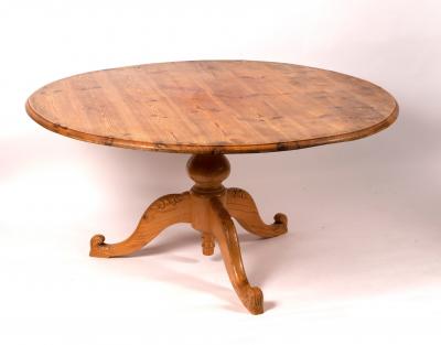 A circular pitch pine table on a