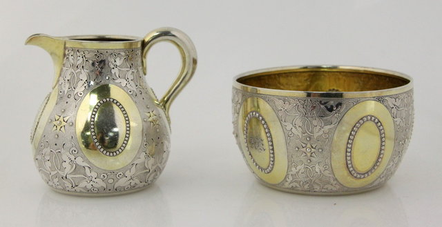 A circular silver sugar basin and