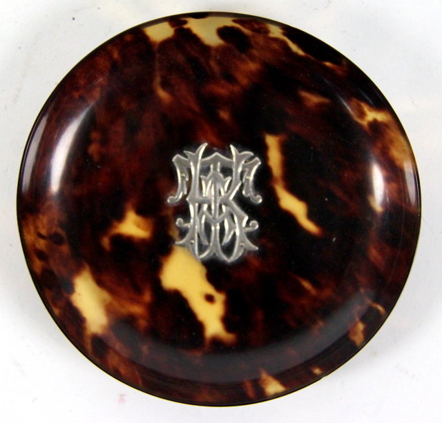 A circular tortoiseshell dish