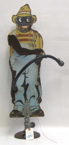 A COLLECTIBLE TIN PAINTED BLACK MAN