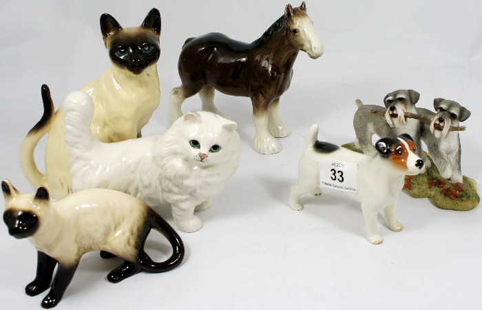 A collection of Pottery Dogs Cats