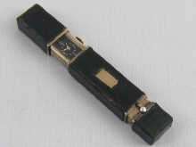 A combination lipstick and watch in