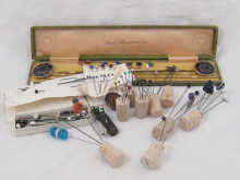 A complete boxed set of hat pins