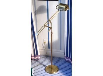 A contemporary brass floor lamp