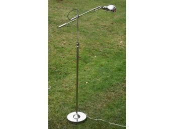 A contemporary chrome floor lamp