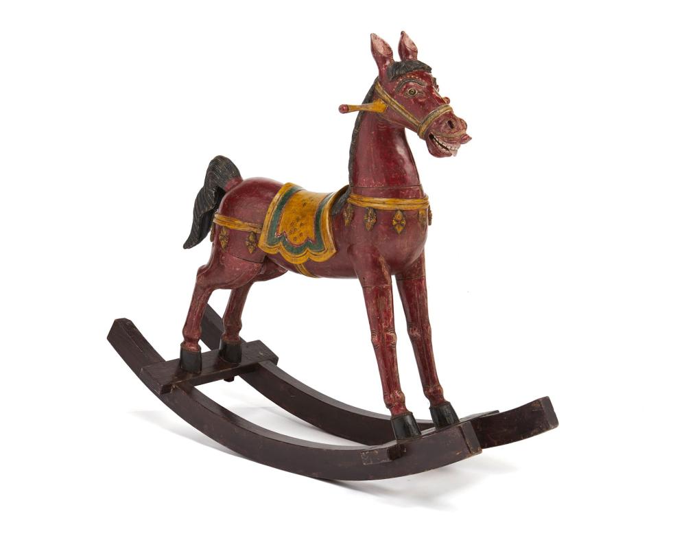 A CONTINENTAL CARVED WOOD ROCKING