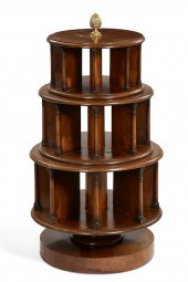 A CONTINENTAL MAHOGANY REVOLVI