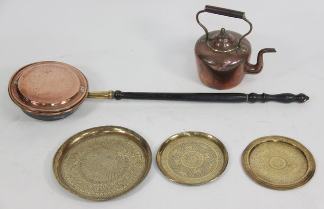A copper warming pan with turned