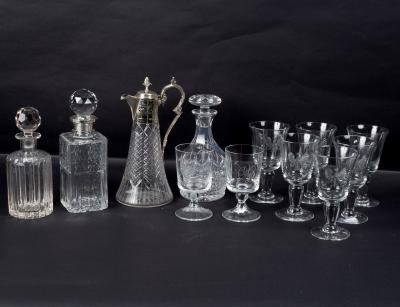 A cut glass decanter with silver