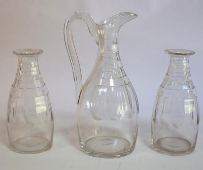 A cut glass ewer and two
