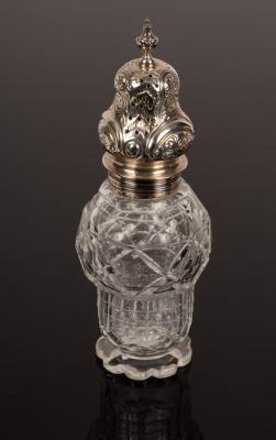 A cut glass sugar caster with