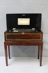 A CYLINDER MUSIC BOX ON STAND.