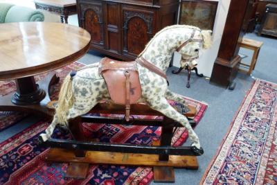 A dapple grey rocking horse on