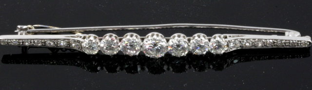 A diamond bar brooch with seven