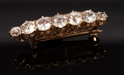 A diamond seven-stone brooch, the