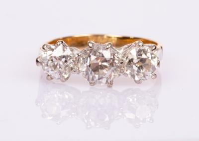 A diamond three-stone ring, the