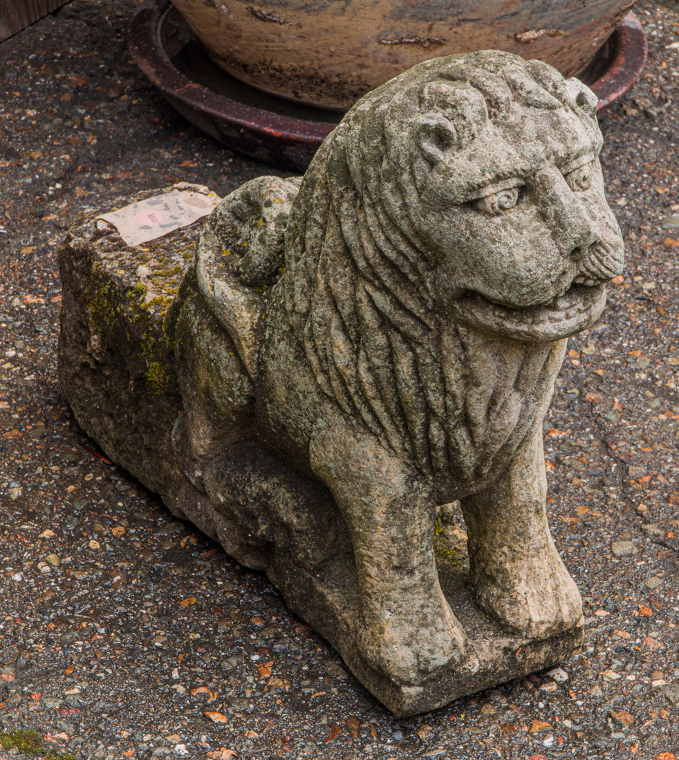 A DIMINUTIVE CARVED LION a