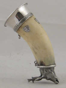 A drinking horn with white metal