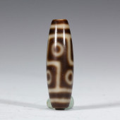 A DZI BEAD WITH DISTINCTIVE ST
