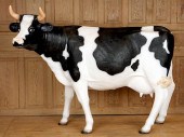 A FIBERGLASS FIGURE OF A COWA