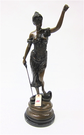 A FIGURAL BRONZE SCULPTURE