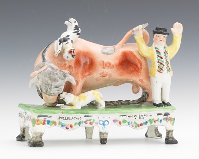 A Figural Group "Bull Beating" "Now