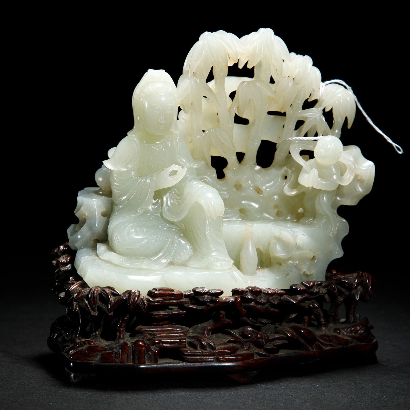 A FINE CARVED JADE GUANYIN AND