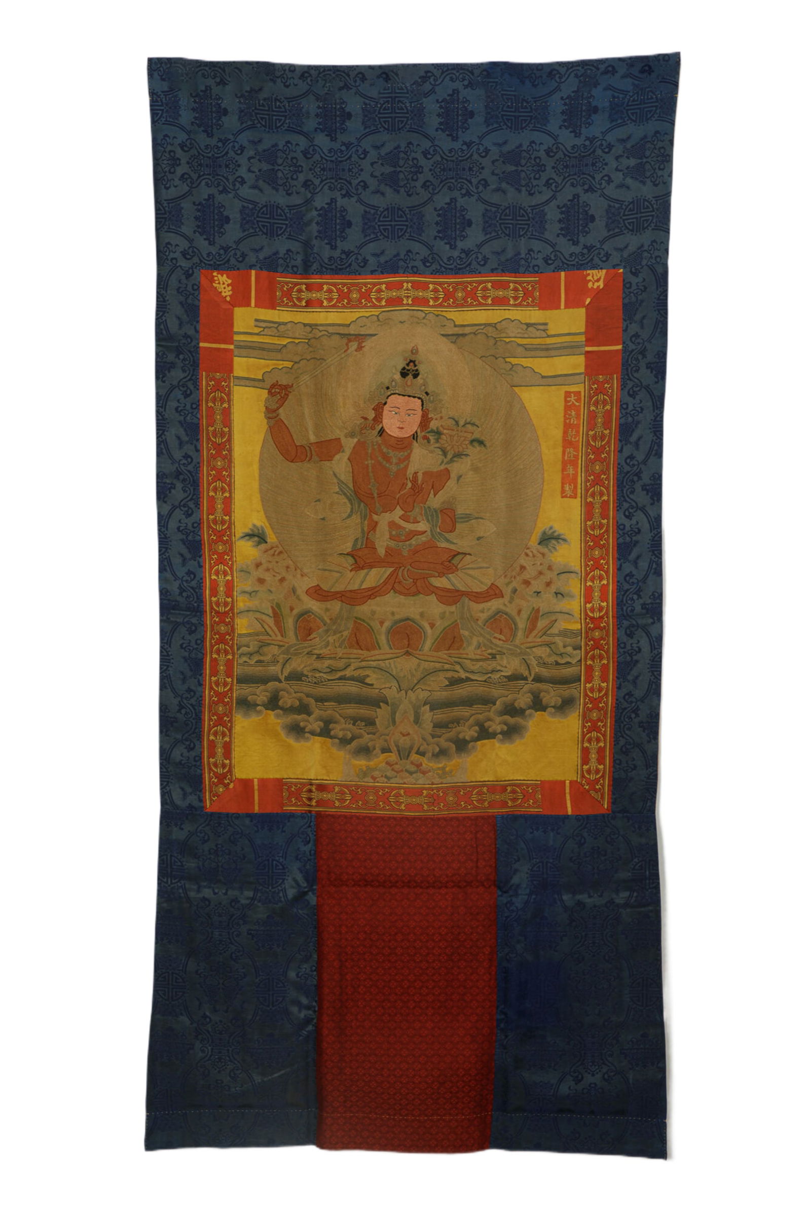 A FINE EMBROIDERED THANGKA OF