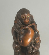 A FINE WOOD NETSUKE OF MONKEY