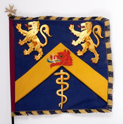 A flag bearing an armorial, with