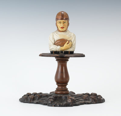 A Football Figural Pipe Rest