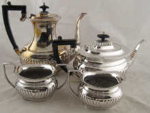 A four piece half fluted silver