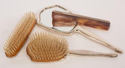 A four piece silver backed dressing