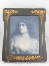 A framed embroidery of a garde