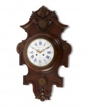 A FRENCH CARVED WALNUT WALL CL