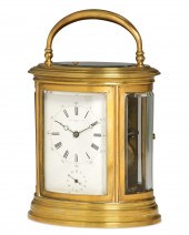A FRENCH GILT BRASS OVAL CARRI