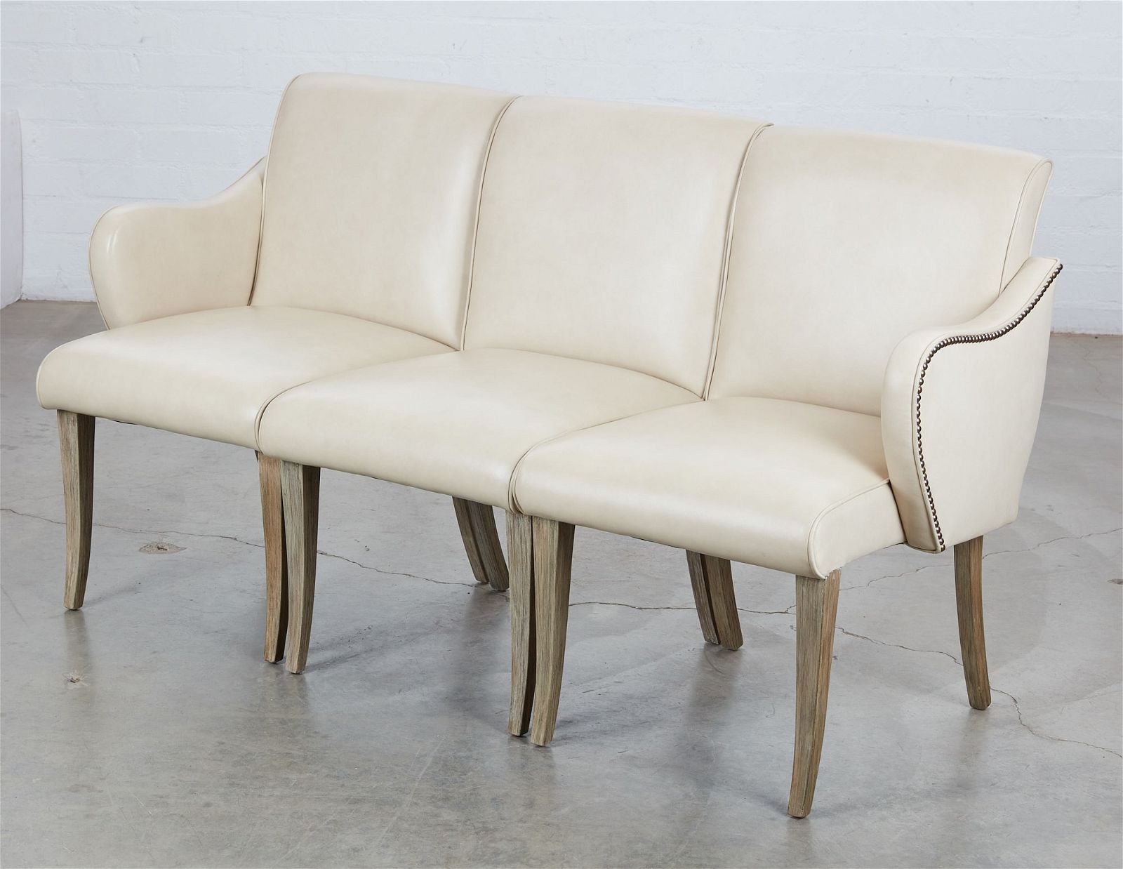A FRENCH UPHOLSTERED THREE SEAT