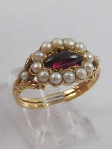 A garnet and pearl ring set in