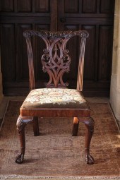 A GEORGE II WALNUT CHAIR in th