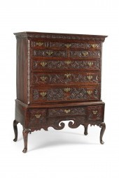 A GEORGE III CARVED OAK CHEST